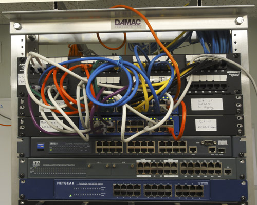 Photo of relay rack with new switches and color-coded patch cords